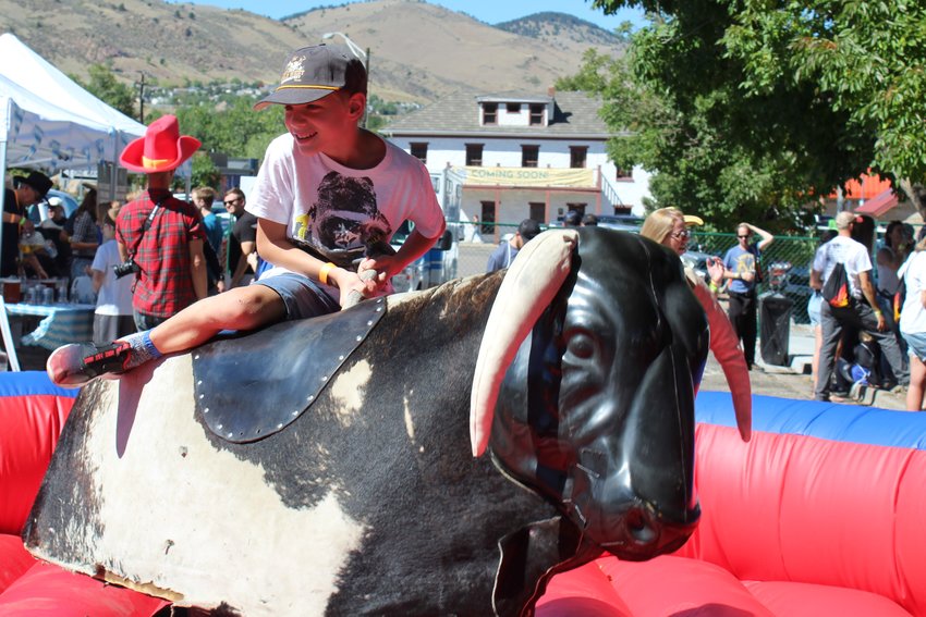 Emil Freeman, 9, rides the mechanical bull at the inaugural Wild West Oktoberfest Sept. 24 in downtown Golden.